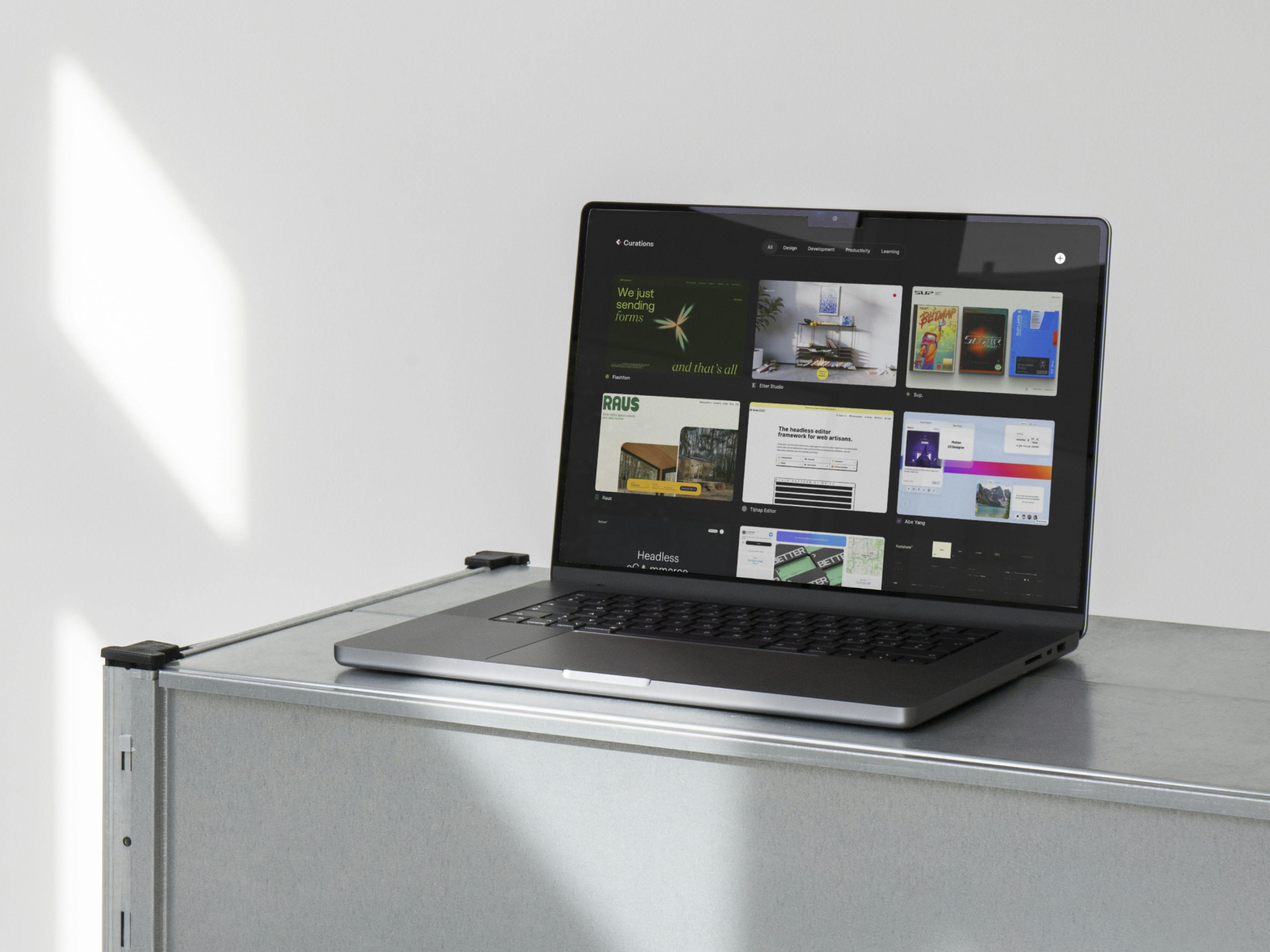 A Mockup of a Macbook with the Curations website open on a shelf